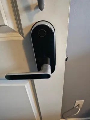 a cell phone sticking out of a door at Navarre Guest Rooms in Columbus
