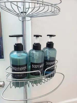 two bottles of detergent on a shelf in a bathroom at Navarre Guest Rooms in Columbus