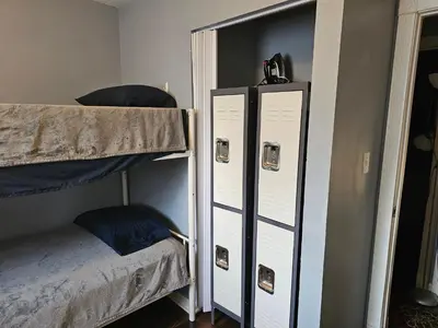a room with two bunk beds next to a door at Navarre Guest Rooms in Columbus
