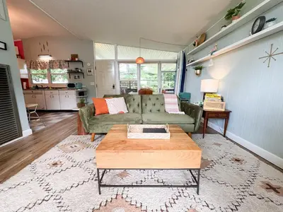 a living room with a couch and a coffee table at Mid-Century Modern Themed Home with Outdoor Hot Tub in Vermilion