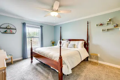 a bedroom with a bed with a ceiling fan at 4 Mi to Dtwn Ohio River Valley Home with Deck! in Aurora