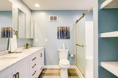 a bathroom with a toilet and a shower at 4 Mi to Dtwn Ohio River Valley Home with Deck! in Aurora