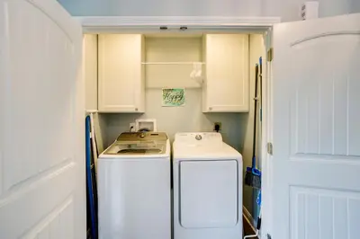 a small kitchen with a stove and a refrigerator at 4 Mi to Dtwn Ohio River Valley Home with Deck! in Aurora