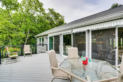 a deck with a glass table and chairs at 4 Mi to Dtwn Ohio River Valley Home with Deck! in Aurora