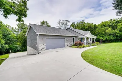 a house with a garage with a driveway at 4 Mi to Dtwn Ohio River Valley Home with Deck! in Aurora