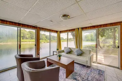 a living room with a couch and chairs and a table at Cozy House on Meadowbrook Lake Serene, Scenic! in Stow