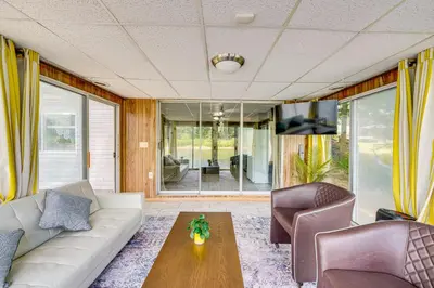 a living room with a couch and chairs and a table at Cozy House on Meadowbrook Lake Serene, Scenic! in Stow