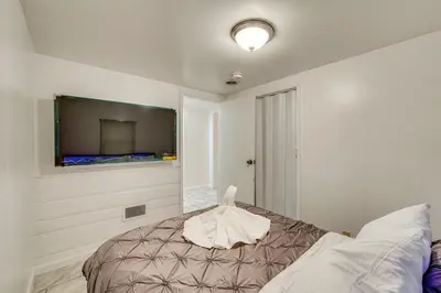 a bedroom with a bed and a flat screen tv at Cozy House on Meadowbrook Lake Serene, Scenic! in Stow