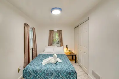 a bedroom with a bed with a towel on it at Cozy House on Meadowbrook Lake Serene, Scenic! in Stow