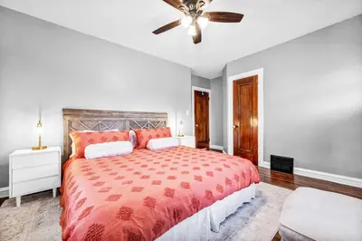 a bedroom with a large bed and a ceiling fan at Suite Dreams Cleveland in Shaker Heights