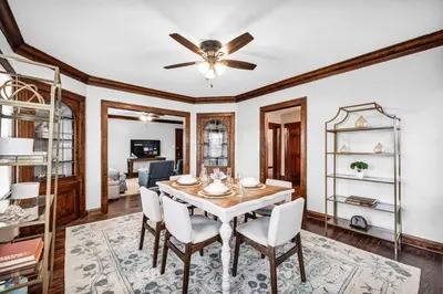a dining room with a table and a ceiling fan at Suite Dreams Cleveland in Shaker Heights