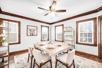 a dining room with a table and a ceiling fan at Suite Dreams Cleveland in Shaker Heights