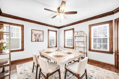 a dining room with a table with chairs and a ceiling fan at Suite Dreams Cleveland in Shaker Heights