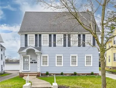 a white house with a gray roof at Suite Dreams Cleveland in Shaker Heights