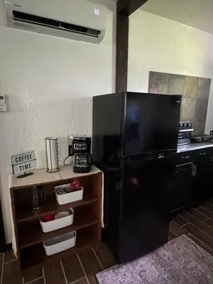 a kitchen with a black refrigerator in a room at River's Rest on Hocking River in Coolville