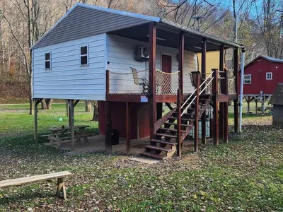 a small house with a staircase and a ramp to it at River's Rest on Hocking River in Coolville
