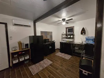 a room with a kitchen with a ceiling fan at River's Rest on Hocking River in Coolville