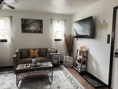 a living room with a couch and a table at River's Rest on Hocking River in Coolville