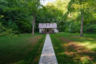 a small house in the middle of a yard at Riverstone Cabin and Retreat in West Liberty