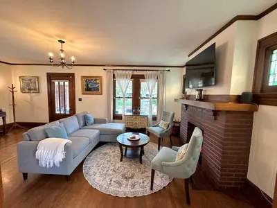a living room with a couch and a fireplace at The Dayton DreamHouse in Dayton