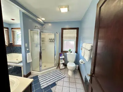 a bathroom with a shower and a toilet and a sink at The Dayton DreamHouse in Dayton