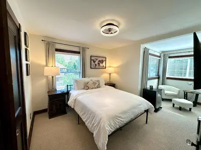 a bedroom with a bed and a large window at The Dayton DreamHouse in Dayton