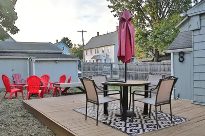 a table with chairs and an umbrella on a deck at Lakewood Entire Home! Sleeps 10! in Lakewood