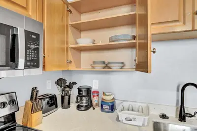 a kitchen counter with a sink and a microwave at Pink playhouse sq near Progressive field & CSU in Cleveland