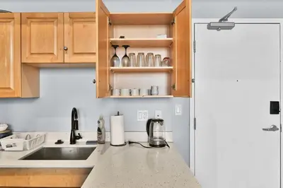 a kitchen with wooden cabinets and a counter top at Pink playhouse sq near Progressive field & CSU in Cleveland