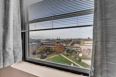 a window with a view of a city at Pink playhouse sq near Progressive field & CSU in Cleveland