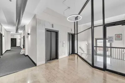 an empty hallway of a building with glass doors at Pink playhouse sq near Progressive field & CSU in Cleveland