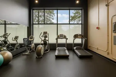 a gym with several cardio machines in a room with windows at Pink playhouse sq near Progressive field & CSU in Cleveland