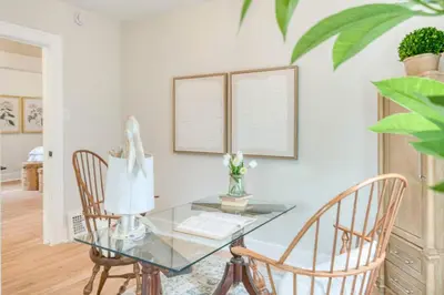 a glass table with a lamp and two chairs at Farmhouse Fresh 4BR Retreat in University Heights