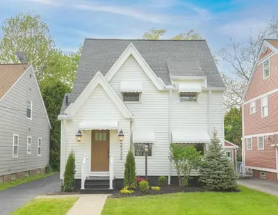 a white house with a gray roof at Farmhouse Fresh 4BR Retreat in University Heights