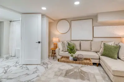 a living room with a couch and a table at Farmhouse Fresh 4BR Retreat in University Heights