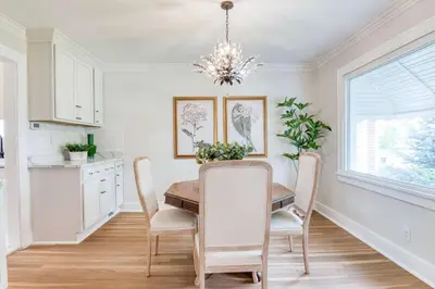 a kitchen and dining room with a table and chairs at Farmhouse Fresh 4BR Retreat in University Heights