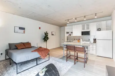 a bedroom with a bed and a kitchen in it at 2 New Studios with Stunning City Views in Cleveland