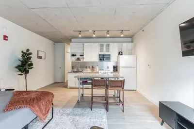 a kitchen with a table and chairs in a room at 2 New Studios with Stunning City Views in Cleveland