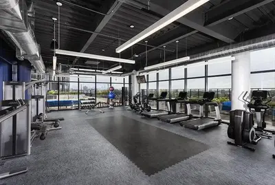 a gym with a bunch of treadmills and machines at 2 New Studios with Stunning City Views in Cleveland
