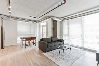 a living room with a couch and a table at 4BR Combined Units at Skyline 776 in Cleveland