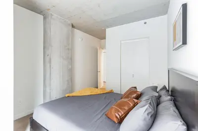 a bedroom with a bed with a leather couch at 4BR Combined Units at Skyline 776 in Cleveland