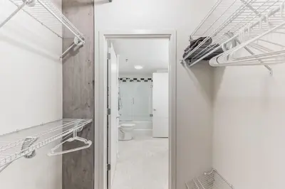 a bathroom with a toilet and a walk in closet at 4BR Combined Units at Skyline 776 in Cleveland