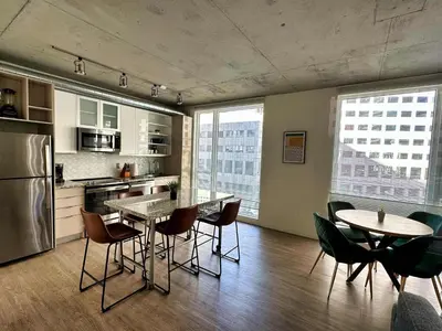 a kitchen with a table and chairs in a room at 3 Brand new combined apartments with city views in Cleveland