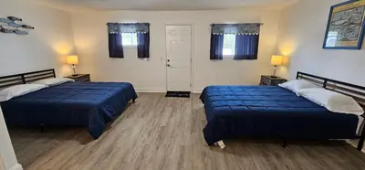 a room with two beds and two lamps in it at Sunrise Inn LLC in Port Clinton