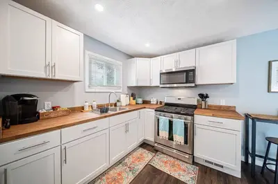 a kitchen with white cabinets and a stove top oven at The Ultimate Lakewood Retreat! in Lakewood