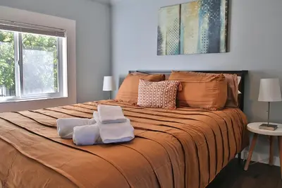 a bedroom with a large bed with two towels on it at The Ultimate Lakewood Retreat! in Lakewood