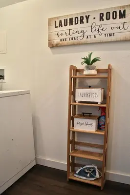 a shelf in a room with a sign on the wall at The Ultimate Lakewood Retreat! in Lakewood