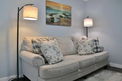 a living room with a couch and two lamps at The Ultimate Lakewood Retreat! in Lakewood