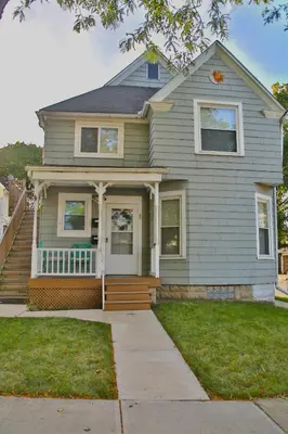 a gray house with a porch and a porch at The Ultimate Lakewood Retreat! in Lakewood