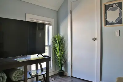 a living room with a flat screen tv on a table at The Ultimate Lakewood Retreat! in Lakewood